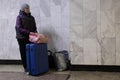 a woman waits at the Kharviv bus station to leave the country at war