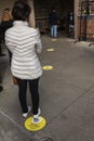 Covid-19,people standing on safe-distance markers waiting in line to shop for groceries at suburban Philadelphia, PA supermarket,