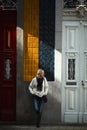 A woman waits standing outside a traditional Portuguese town house. Royalty Free Stock Photo