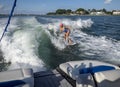 Woman wakesurfing behind boat in Florida during summer