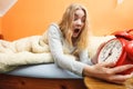 Woman waking up late turning off alarm clock. Royalty Free Stock Photo