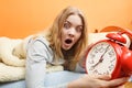 Woman waking up late turning off alarm clock. Royalty Free Stock Photo