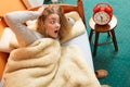 Woman waking up late turning off alarm clock. Royalty Free Stock Photo