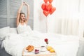 Woman waking up with surprise in the bed