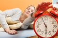 Woman waking up turning off alarm clock in morning Royalty Free Stock Photo