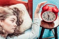 Woman waking up turning off alarm clock in morning Royalty Free Stock Photo