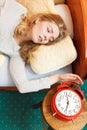 Woman waking up turning off alarm clock in morning Royalty Free Stock Photo