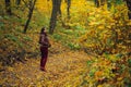 Woman walk in autumn forest