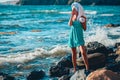 Woman walk on coastline. Lady wearing towel on head. Beauty treatment and relaxation. Wellness, spa concept. Copy space