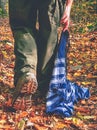 Woman walk and hold colorful scarf lying on dry leaves Royalty Free Stock Photo