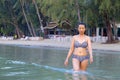 Woman walk relax in water morning at beach Royalty Free Stock Photo