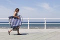 Woman walk on seafront of GijÃÂ³n