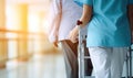 Woman With Walker Walking Down Hallway Royalty Free Stock Photo