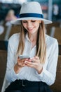 Woman walking in airport and looking at mobile phone Royalty Free Stock Photo