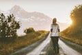 Woman walking alone on gravel road in mountains Royalty Free Stock Photo