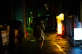 A woman is walking alone at the night street in the rainy season Royalty Free Stock Photo