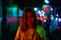 A woman is walking alone at the night street in the rainy season Royalty Free Stock Photo