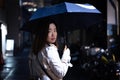 A woman is walking alone at the night street in the rainy season Royalty Free Stock Photo