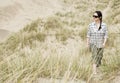 Woman walking alone in sand dunes