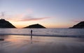 Woman walking along the beach and bay of La Concha, sunset in the city of Donostia-San Sebastian, Basque Country Royalty Free Stock Photo