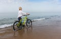 Woman walking along a beach in shallow water Royalty Free Stock Photo