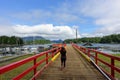 A woman walking along a dock at the harbour in Tofino, overlooking the beautiful ocean and islands in the background, in Tofino Royalty Free Stock Photo