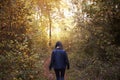 Woman Walking Along Path In Autumn Woodland Royalty Free Stock Photo