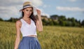 Woman is walking along the road among the fields Royalty Free Stock Photo