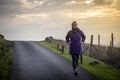 Woman walking along Scottish island road