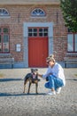 Woman walking with an American Stafford in the park