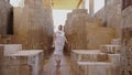 Woman is walking amongst world's oldest known stone columns.