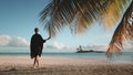 Woman walking barefoot white sand beach at sunset. Royalty Free Stock Photo