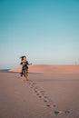 Woman walking at the beach of Maspalomas Gran Canaria Spain, girl at the sand dunes desert of Maspalomas Royalty Free Stock Photo