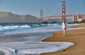 Woman walking on beach near Golden Gate Bridge Royalty Free Stock Photo