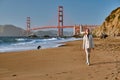 Woman walking on beach near Golden Gate Bridge Royalty Free Stock Photo