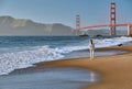 Woman walking on beach near Golden Gate Bridge Royalty Free Stock Photo