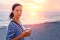 Woman walking on the beach in the surf at sunset Royalty Free Stock Photo