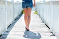 Woman walking on boardwalk out to ocean Royalty Free Stock Photo