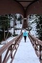 Woman walking on bridge over the frozen river. Royalty Free Stock Photo