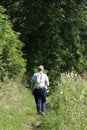 Woman walking on canal towpath Cumbria countryside