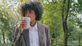 Woman walking city park enjoying coffee takeaway closeup. Business lady drinking Royalty Free Stock Photo