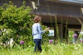 Woman walking in city park looking at her mobile phone Royalty Free Stock Photo