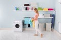 Woman Walking With Clothes In Utility Room Royalty Free Stock Photo