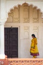 Woman walking in colonnade walkway leading to Diwan-i- Khas, Agra Fort, Uttar Pradesh, India