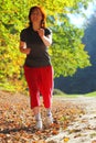 Woman walking cross country trail in autumn forest Royalty Free Stock Photo