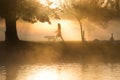 Early morning mist and fog over lake with passers by Royalty Free Stock Photo