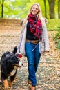 Woman walking the dog on leash in park Royalty Free Stock Photo