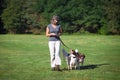 Woman walking with dogs on leash