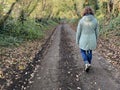 Woman walking in the woods, seen from behind