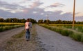 Woman walking down a country road Royalty Free Stock Photo